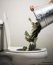 money being poured down toilet